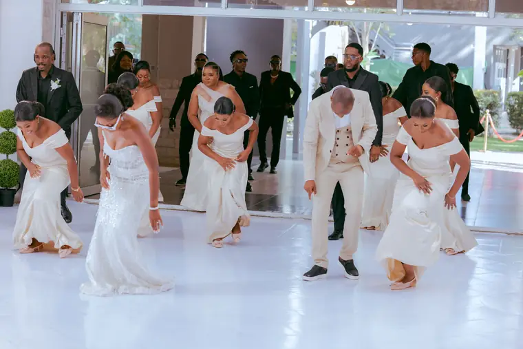 Bridesmaids and groomsmen dancing in formation
