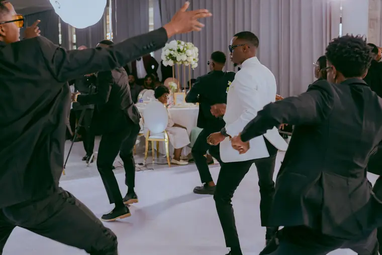 Groomsmen jumping together on the dance floor