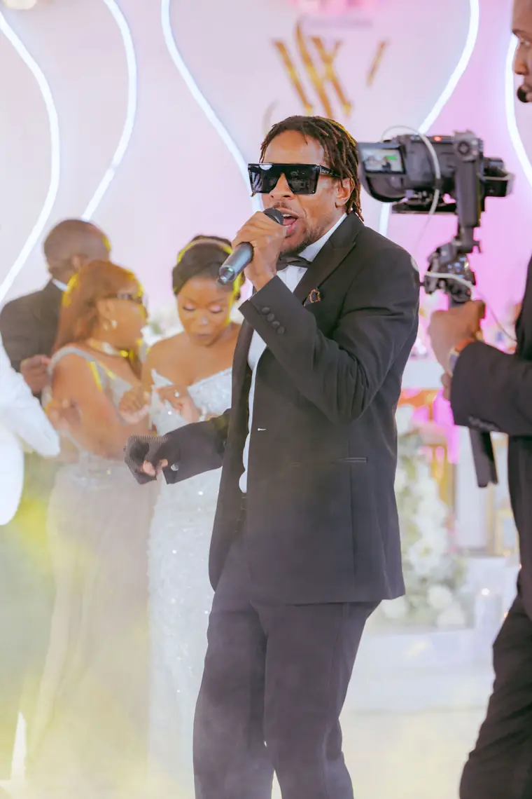 A performer with a microphone leading the crowd, a camera operator behind