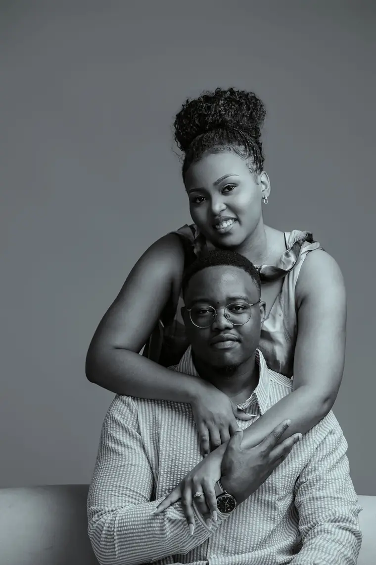 A black and white studio portrait of a couple