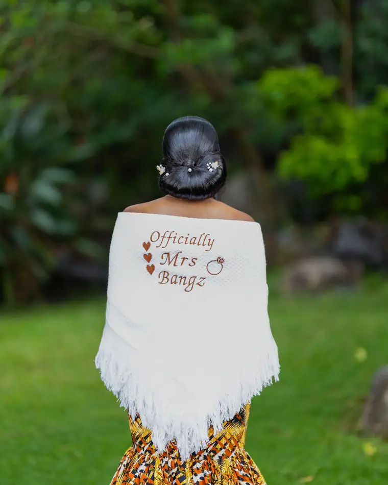 A bride's shawl embroidered Officially Mrs, seen from behind