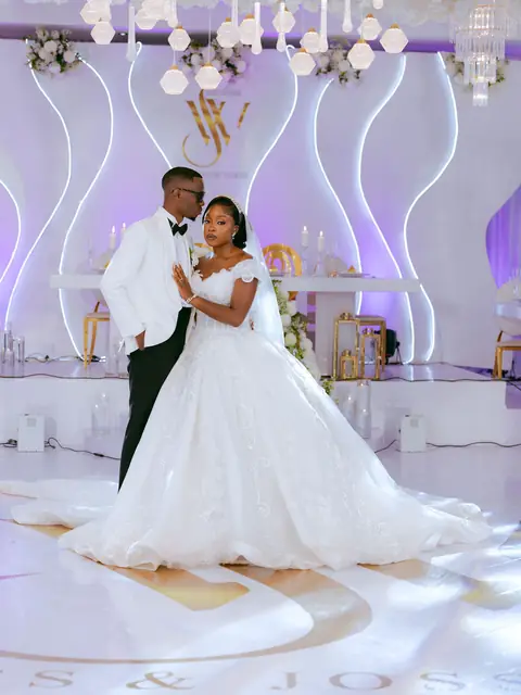 A couple holding each other on a lit dance floor